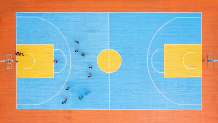 Top view of the basketball court during the game. The players are on the field, spectators on the...