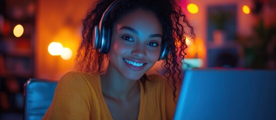 Young woman with headphones working late at night