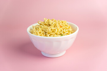 Boiled instant noodles on pink background. Fast food. Modern food. bright pink background color.