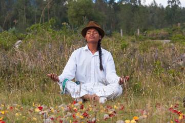 Man meditating in nature surrounded by flower petals