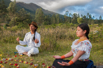 Indigenous people meditating in nature with flower petals and stones