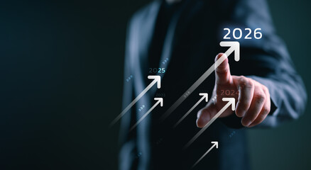 Business growth strategy for 2026. A businessman points to future success, symbolizing company development, planning, opportunity, and motivation for business success in the upcoming year. © Looker_Studio