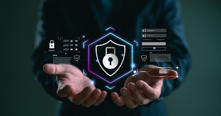 Cybersecurity and data protection concept. A businessman holds a digital shield with lock icon, login form, and binary code, representing online privacy, secure access, and information safety.