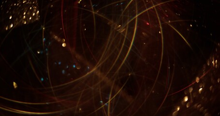 Blur garland swirling. Sparkling gold flashes. Glowing particles lens flare with glow on bokeh...