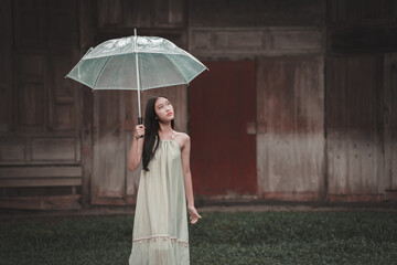 Teenage girl with umbrella outdoor location portrait style serene environment dreamy viewpoint