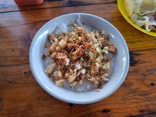 Rice bowl fried chicken coated with salted egg and half-cooked fried egg for lunch or dinner
