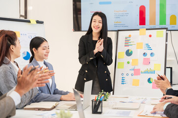 Businesspeople applaud and congratulate the team.