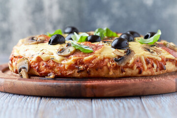 Thick crust pizza with cheese, salami, champignon mushrooms, black olives and fresh basil.	