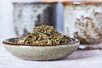 Dried Green Tea Leaves on Bright Background. Close up.	