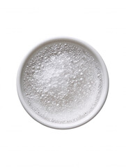 An overhead view showcases a pristine white ceramic bowl filled with effervescent bubbles and glistening clear liquid, set against a clean white background adding purity.