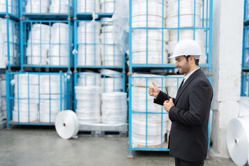 Standing amid modern machinery, the European male engineer evaluates the integration of automation and data analytics, advancing the industry’s capabilities in the global market.