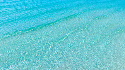 Nature of the beach and sea Summer with sunshine, sandy beaches, clear blue waters sparkling against the blue sky. On an island with good ecology and environment Background for summer vacation