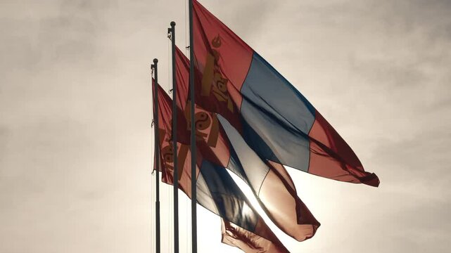 Sunset view of Mongolian flags waving in Ulan Bator with the golden light of the setting sun in the background