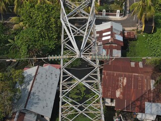 Electricity generated from generation is distributed through transmission towers before reaching consumers. Transmission towers pass on the roof of densely populated residential house in a city