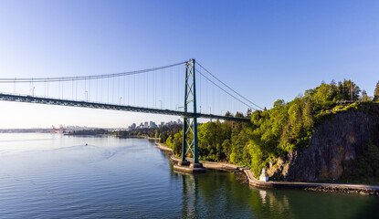 Lions Gate Bridge Over Scenic Vancouver Harbor with Lush Stanley Park Foliage