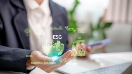 Businesswoman holding ESG icon with carbon dioxide and eco-friendly infographic, sustainability,...