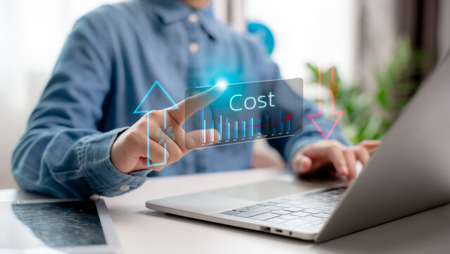 Hand pointing to cost reduction graph on laptop with down arrow and percentage icon, representing business expense control, strategic budgeting, and financial efficiency.