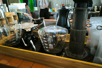 A close-up photo of a barista's counter with various tools for serving delicious coffee.