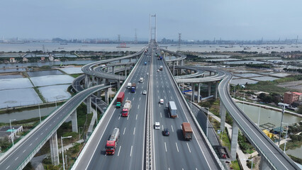 Logistic bridge China. Lot cargo car drive transport road traffic. Chinese aerial top view, fast urban long highway. Modern city, busy auto express way, freight delivery. Asian economy development.