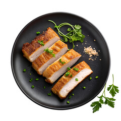 Crispy roasted pork belly slices on a black plate top view on white background