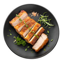 Crispy roasted pork belly slices on a black plate top view on white background
