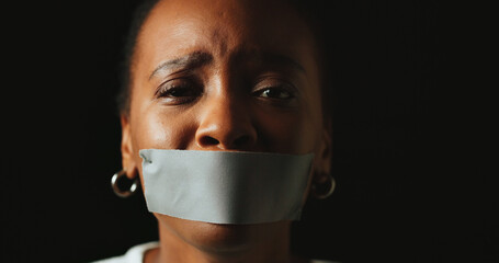 Woman, tape and mouth with stress in studio for silence, voice and anxiety by black background....