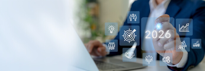 2026 new year business goals and strategic planning, challenge business target in 2026. Businessman interacts futuristic digital icons representing business strategies and growth. Corporate plan 2026.