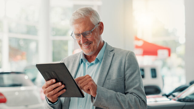 Businessman, smile and scroll with tablet for dealership, reading and website for car rental service. Showroom, mature person and seller with digital for inventory information, vehicle shop or typing