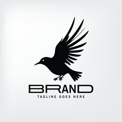 Obraz premium Black silhouette of a bird in flight against a plain background. Modern design for a company logo or brand identity.