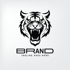 Fototapeta premium Tiger head logo design with brand name and tagline space. Bold graphic of a roaring tiger head presented in black and white against a light gray background.