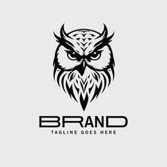 Obraz premium Owl logo design for brand with a simple, bold aesthetic. Intricate, stylized owl head graphic in a monochromatic color scheme.