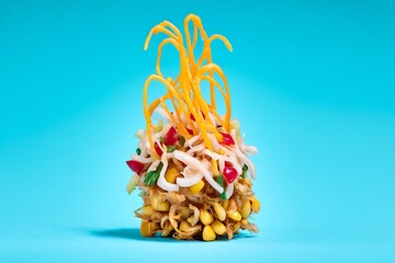 Artistic corn salad on blue backdrop