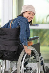 Plakat handicapped woman on wheelchair exiting a building
