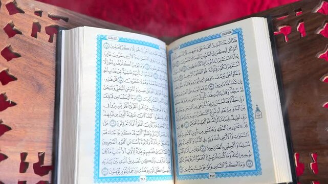 Holy Quran Open on Rehal with Red Prayer Rug &ndash; 4K Islamic Spiritual Footage