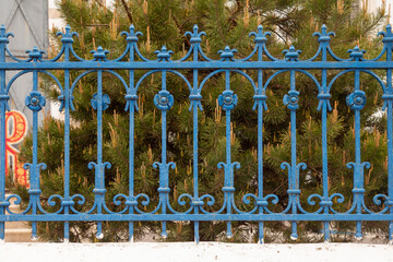 Antique wrought iron ornate fence in blue