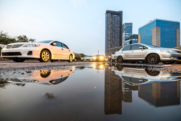 A car driving past a flooded area in an urban.