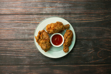 Crispy Chicken Fry served in plate isolated on wooden background top view of bangladeshi food