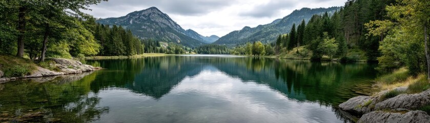 Scenic view of lake in pine forest near beautiful mountain concept. Scenic mountain landscape with a tranquil lake and reflection.
