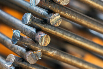 Stack of steel rods with rough cuts, close-up view