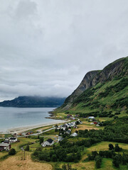 Fototapeta premium Coastal village nestled between mountains and sea