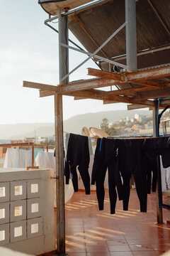 Wetsuits Drying on a Rooftop After Surfing &ndash; Awrir, Morocco