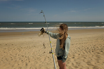 Teenage girl cleans plastic from ocean Cape Hatteras National Se