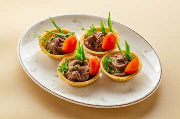 tartlets with chicken pate and herbs on a plate