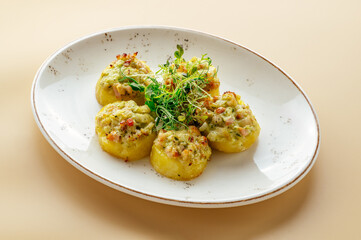 baked potatoes with filling and herbs on a plate