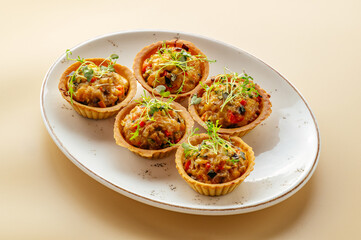 baked tartlets with filling on a plate