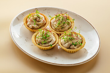 tartlets with pate and herbs on a plate