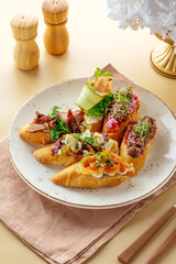 assorted bruschetta with toppings on a plate