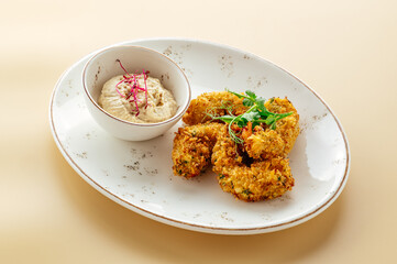 breaded chicken with sauce and herbs