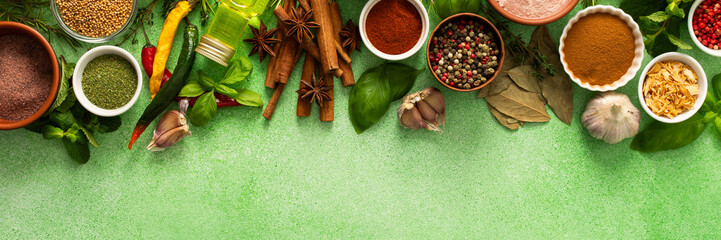 A beautiful collection of colorful spices and herbs, showcasing their natural aromas and vibrant...
