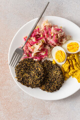 A nutritious breakfast featuring quinoa pancakes, fresh cabbage, radish, mung bean sprouts, boiled eggs, hummus, and roasted beets, perfect for a balanced start to your day